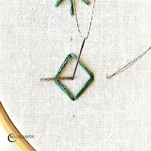 two straight stitches added horizontally across the middle of the diamond