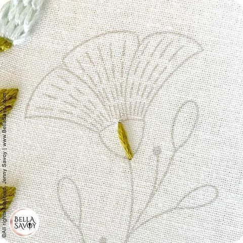 single embroidery stitch placed in the middle of a flower receptacle