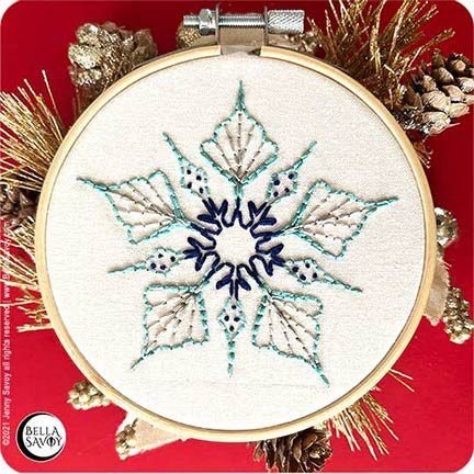 simple 5 point snowflake embroidery pattern finished and set in a hoop