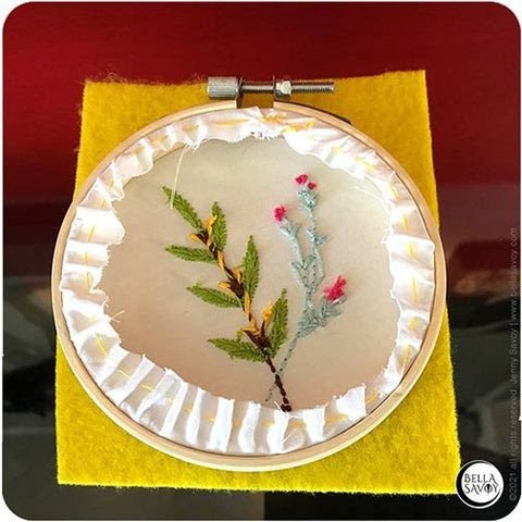 messy thread showing on the back of a finished embroidery hoop