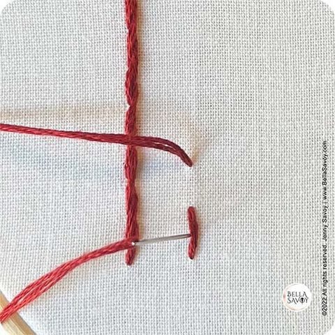 needle returning to the back on left side of 1st stitch