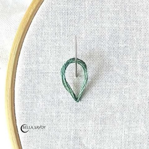 loop with a needle coming up through it