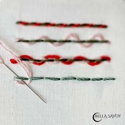 back stitch with pink thread coming up 2nd stitch then back down 1st stitch with needle over the thread along bottom