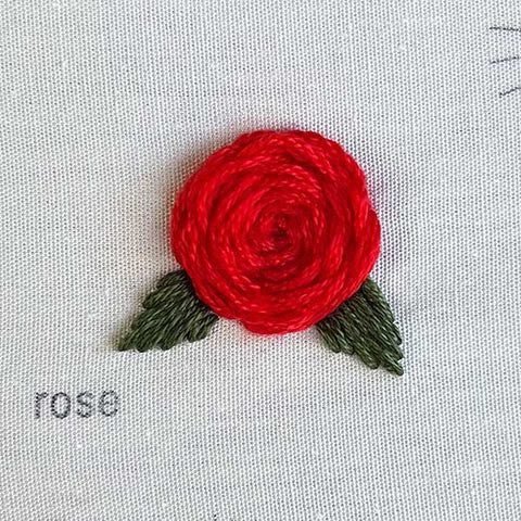 complete rose stitched using the woven wheel and satin stitch