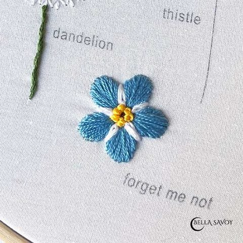 forget-me-not finished with the satin stitch, lazy daisy stitch, and french knots