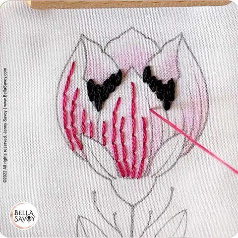 adding embroidery stitches over the colored petals