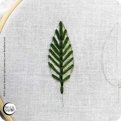 leaf made using open fill fly stitch in green