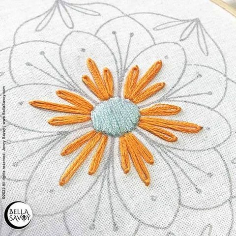 center of embroidery design filled in with a satin stitch and lazy daisy stitches