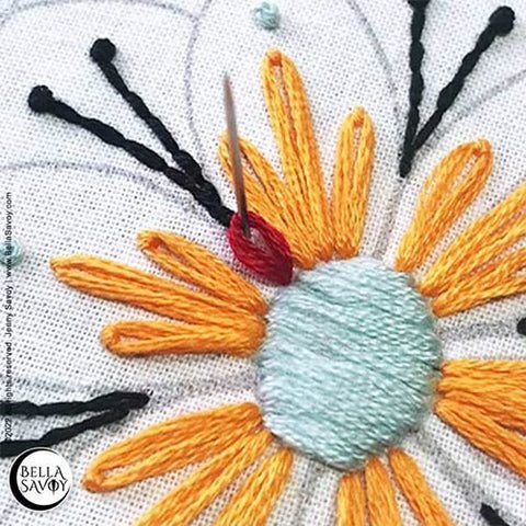 small red lazy daisy stitch being added between each petal