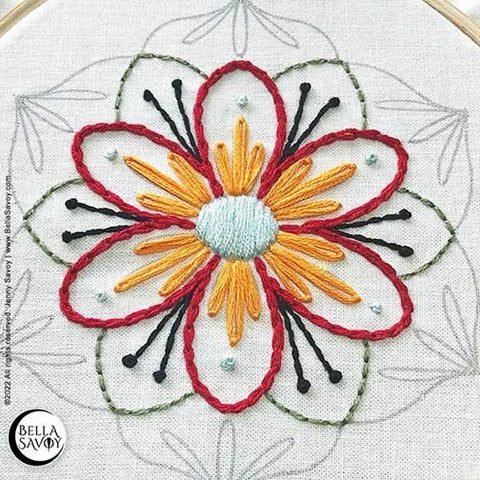 center of mandala embroidery complete with the chain stitch, lazy daisy stitch, satin stitch, and french knots