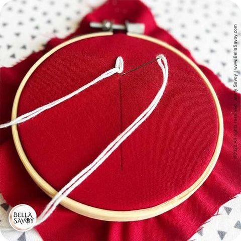 needle returning to the back below the loop