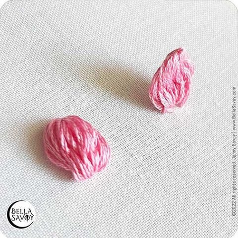 popcorn lazy daisy stitches, one flat against the fabric, and the other standing up