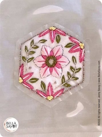 a finished embroidery pattern in water to dissolve the stick and stitch sticker