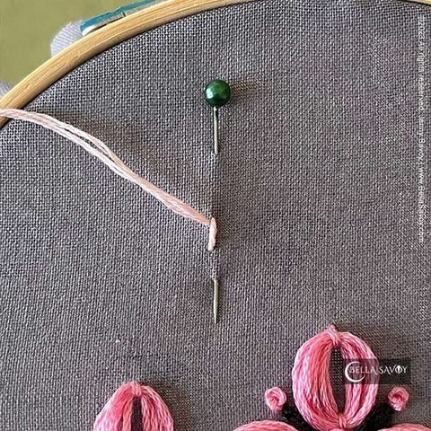 pin through fabric with thread stitched in
