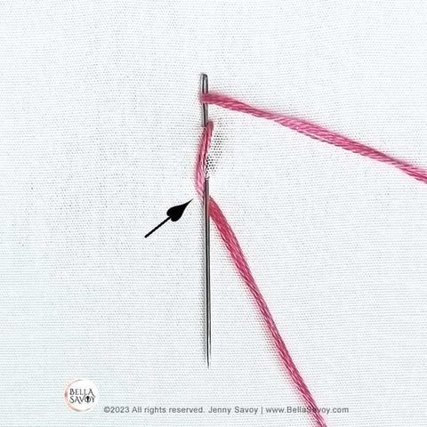 needle slid under the right leg of stitch.