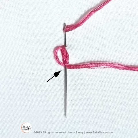 needle pinned from top of stitch to the bottom