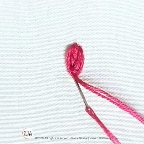 needle returning to the back at the very bottom of oyster stitch