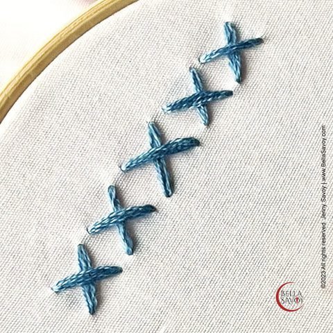 row of 5 blue cross stitch